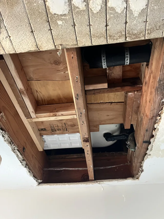 Opened ceiling in an AWC project photo showing exposed framing and plumbing