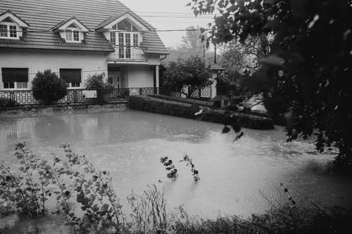 Illustrative residential property surrounded by floodwater